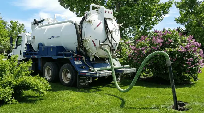 Professional vacuum truck performing residential drainage and septic maintenance in Green Bay, WI