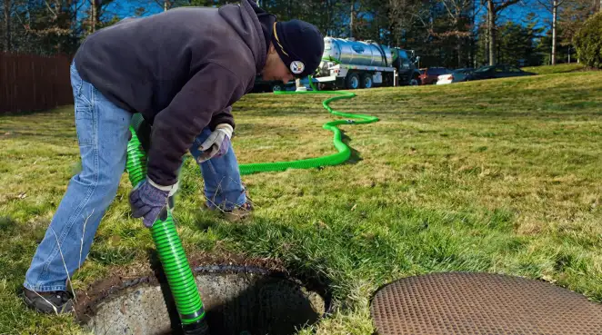 Service technician performing residential septic pumping and drainage maintenance in Green Bay, WI
